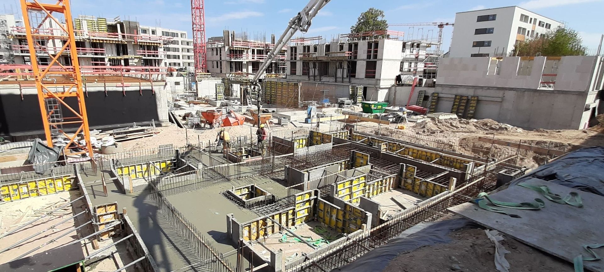 Baustelle mit Bauarbeitern, Maschinen und Transportbeton-Mischern auf einem Baugelände in Viernheim